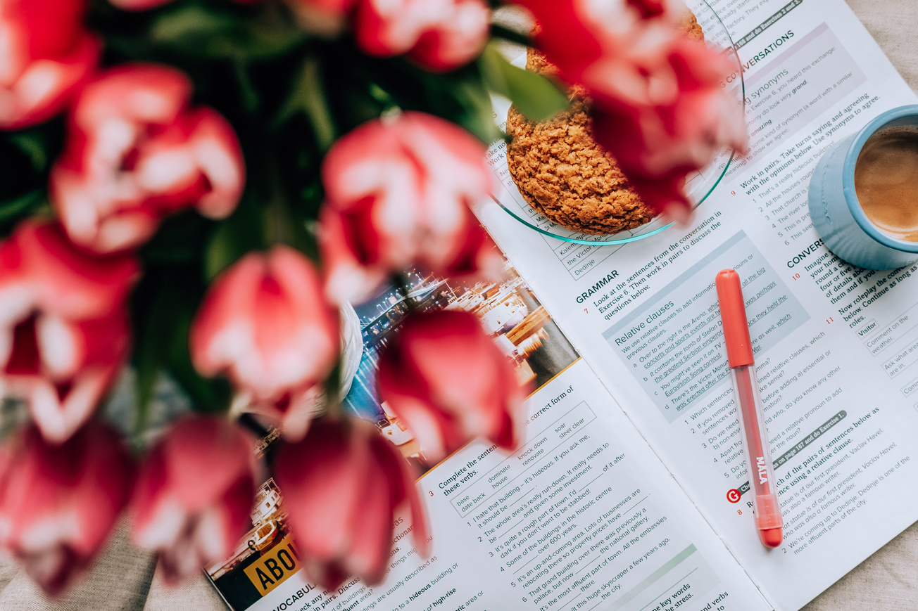 Flowers and breakfast food on textbook